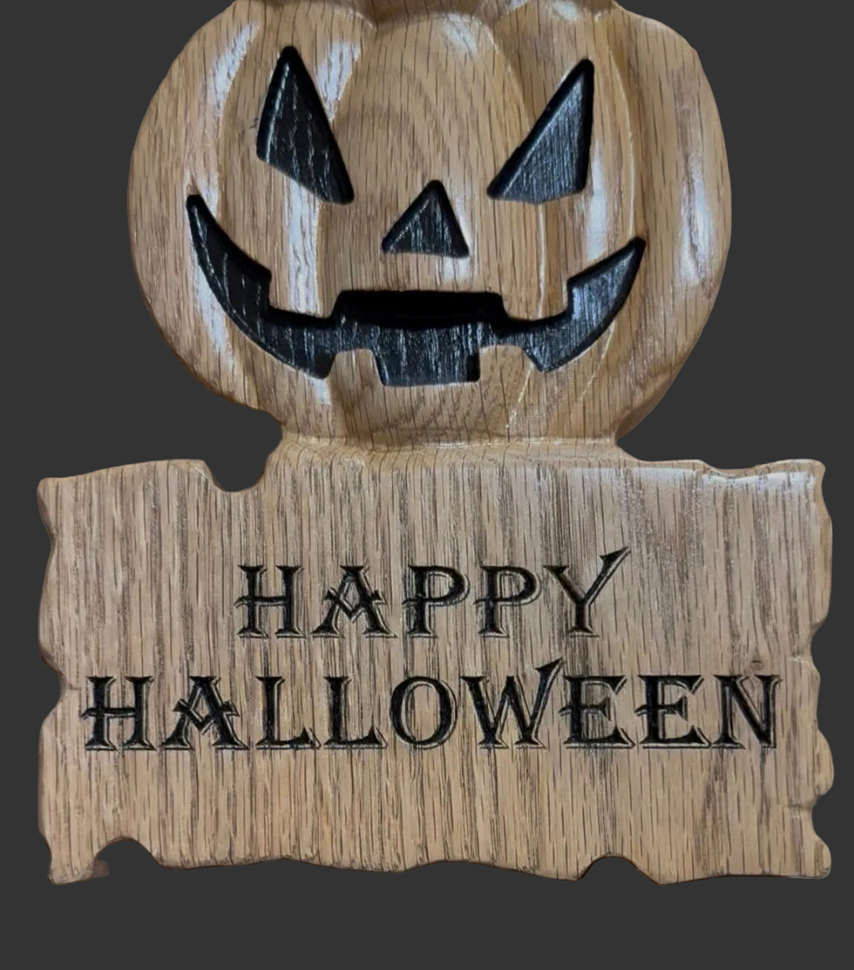 Oak wooden pumpkin decor with happy halloween carved in black lettering