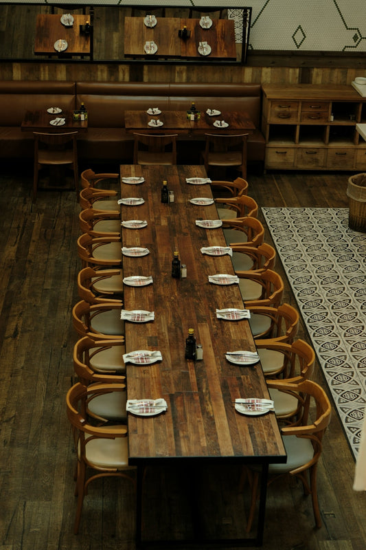 Long wooden table set for a large group meal