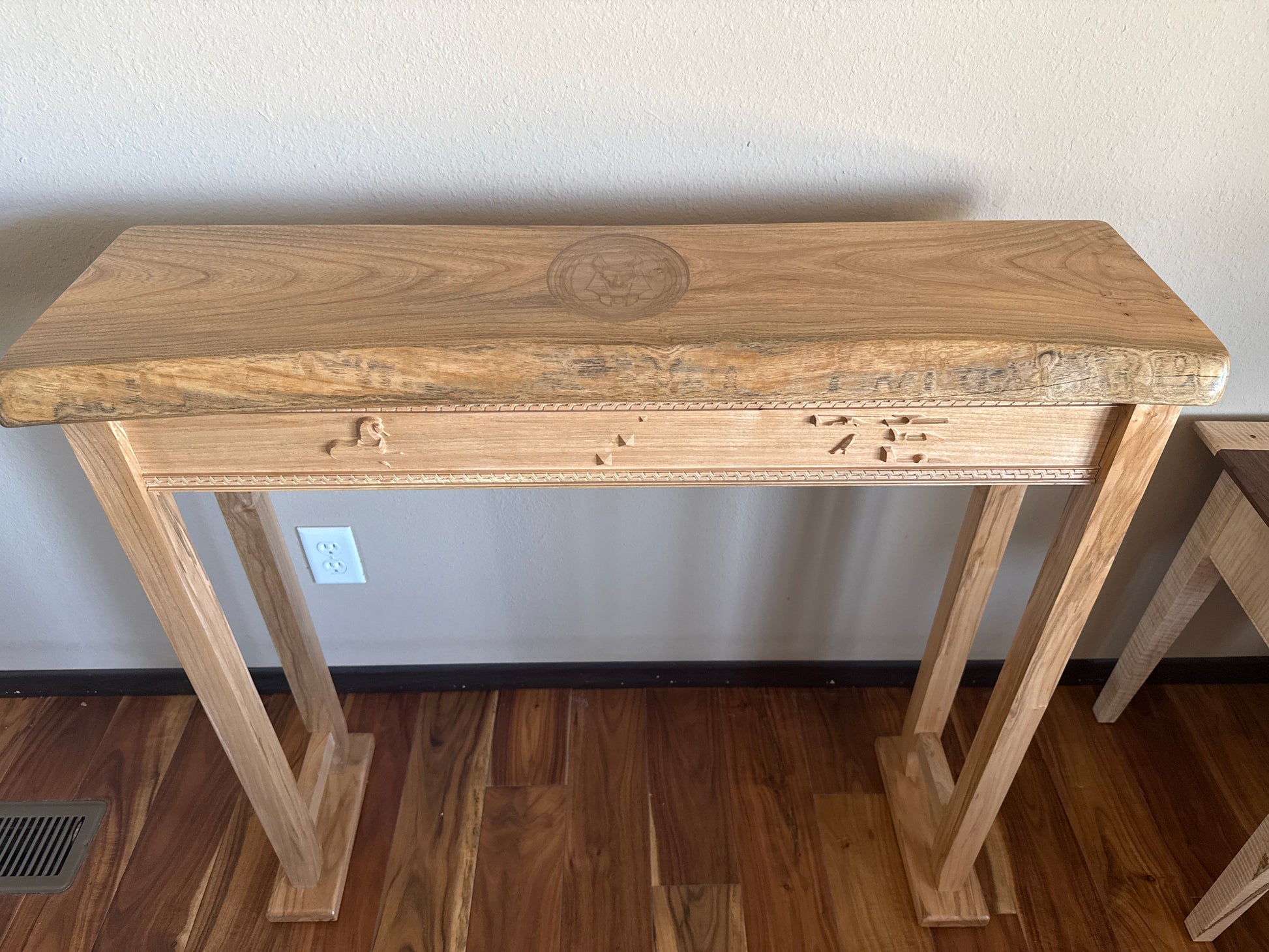 Wooden console table against a plain wall